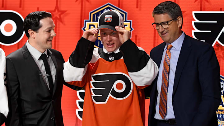 Jun 28, 2023; Nashville, Tennessee, USA; Philadelphia Flyers draft pick Matvei Michkov puts on his hat after being selected with the seventh pick in round one of the 2023 NHL Draft at Bridgestone Arena. Mandatory Credit: Christopher Hanewinckel-Imagn Images