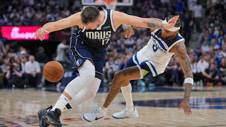 Oct 29, 2024; Minneapolis, Minnesota, USA; Dallas Mavericks guard Luka Doncic (77) dribbles past Minnesota Timberwolves guard Nickeil Alexander-Walker (9) in the fourth quarter at Target Center.