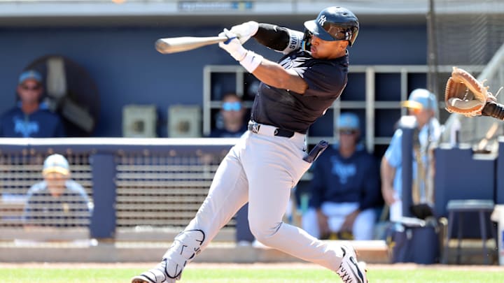 Mar 15, 2025; Port Charlotte, Florida, USA; New York Yankees second base Jorbit Vivas (90) singles during the second inning against the Tampa Bay Rays at Charlotte Sports Park. 