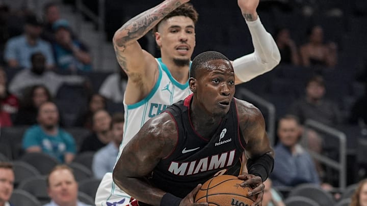 Oct 8, 2024; Charlotte, North Carolina, USA; Miami Heat guard Terry Rozier (2) passes pressured by Charlotte Hornets guard LaMelo Ball (1) during the first quarter at Spectrum Center. Mandatory Credit: Jim Dedmon-Imagn Images