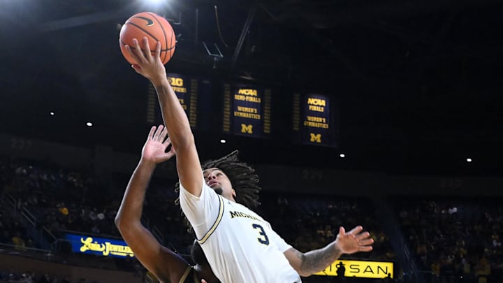 Nov 3, 2025; Ann Arbor, Michigan, USA; Michigan Wolverines guard Elliot Cadeau (3) drives to the basket against Oakland Golden Grizzlies forward Tuburu Naivalurua (12) in the second half at Crisler Center. Mandatory Credit: Lon Horwedel-Imagn Images