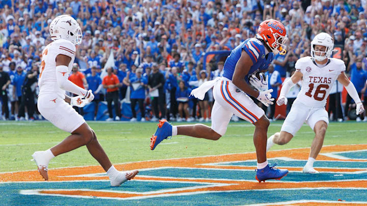 Oct 4, 2025; Gainesville, Florida, USA; Florida Gators wide receiver Dallas Wilson (6) makes a catch for a touchdown while Texas Longhorns defensive backs Kobe Black (6) and Michael Taaffe (16) watch.