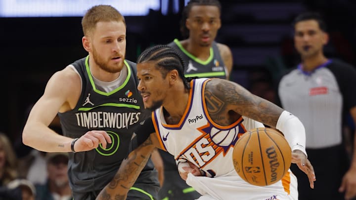 Mar 17, 2026; Minneapolis, Minnesota, USA; Phoenix Suns guard Jalen Green (4) brings the ball up against Minnesota Timberwolves guard Donte DiVincenzo (0) in the third quarter at Target Center. Mandatory Credit: Bruce Kluckhohn-Imagn Images