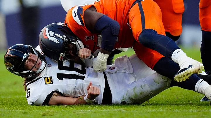 Denver Broncos defensive tackle Malcolm Roach (97) hits Jacksonville Jaguars quarterback Trevor Lawrence (16). Denver Broncos defensive tackle Malcolm Roach (97) hits Jacksonville Jaguars quarterback Trevor Lawrence (16).