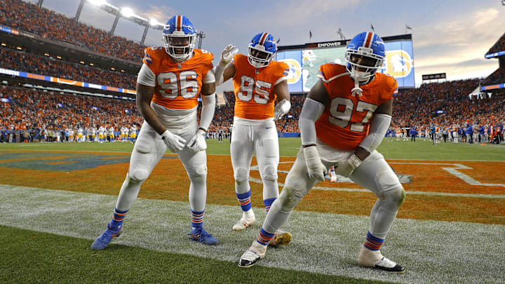 Jan 4, 2026; Denver, Colorado, USA; Denver Broncos defensive end Eyioma Uwazurike (96), defensive end Sai'vion Jones (95) and defensive tackle Malcolm Roach (97) reacts after a fumble recovery during the second half at Empower Field at Mile High. Mandatory Credit: Isaiah J. Downing-Imagn Images