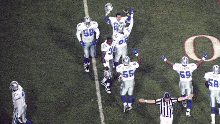 Jan 28, 1996; Tempe, AZ, USA; FILE PHOTO; Dallas Cowboys defenders Scott Case (25), Shante Carver (96), Godfrey Myles (98), David Lang (38), Robert Jones (55) and Darrin Smith (59) react on the field against the Pittsburgh Steelers during Super Bowl XXX at Sun Devil Stadium. Dallas defeated Pittsburgh 27-17. Mandatory Credit: David Petkiewicz/The Arizona Republic-Imagn Images