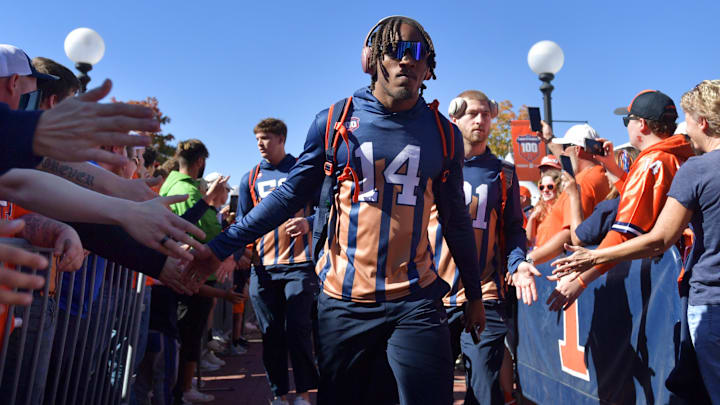 Oct 19, 2024; Champaign, Illinois, USA; Illinois Fighting Illini defensive back Xavier Scott (14) and teammates do the Illini Walk before kickoff against the Michigan Wolverines game at Memorial Stadium. Mandatory Credit: Ron Johnson-Imagn Images