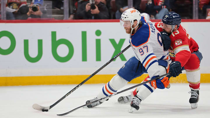 Jun 17, 2025; Sunrise, Florida, USA; Edmonton Oilers center Connor McDavid (97) controls the puck defended by Florida Panthers center Sam Reinhart (13) during the first period in game six of the 2025 Stanley Cup Final at Amerant Bank Arena. Mandatory Credit: Sam Navarro-Imagn Images