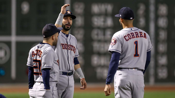 Sep 9, 2018; Boston, MA, USA; Houston Astros center fielder George Springer (4) speaks with Houston Astros shortstop Carlos Correa (1) and Houston Astros second baseman Jose Altuve (27) before their game against the Boston Red Sox at Fenway Park.