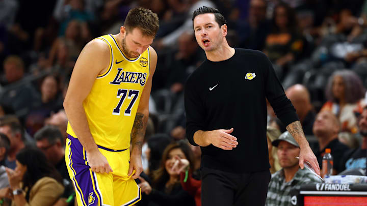 Oct 14, 2025; Phoenix, Arizona, USA; Los Angeles Lakers guard Luka Doncic (77) with head coach JJ Redick against the Phoenix Suns during an NBA preseason game at Mortgage Matchup Center. Mandatory Credit: Mark J. Rebilas-Imagn Images
Oct 14, 2025; Phoenix, Arizona, USA; Los Angeles Lakers guard Luka Doncic (77) with head coach JJ Redick against the Phoenix Suns during an NBA preseason game at Mortgage Matchup Center. Mandatory Credit: Mark J. Rebilas-Imagn Images