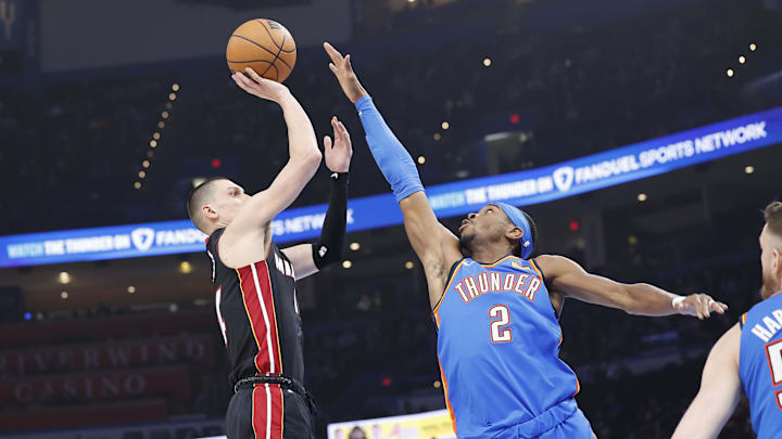 Feb 12, 2025; Oklahoma City, Oklahoma, USA; Miami Heat guard Tyler Herro (14) shoots as Oklahoma City Thunder guard Shai Gilgeous-Alexander (2) defends during the first quarter at Paycom Center. Mandatory Credit: Alonzo Adams-Imagn Images