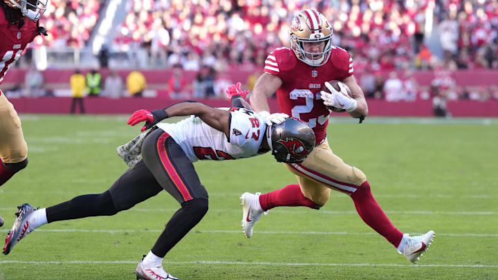 Nov 19, 2023; Santa Clara, California, USA; San Francisco 49ers running back Christian McCaffrey (23) carries the ball against Tampa Bay Buccaneers cornerback Zyon McCollum (27) during the third quarter at Levi's Stadium. Mandatory Credit: Darren Yamashita-Imagn Images