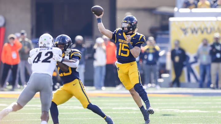 Nov 8, 2025; Morgantown, West Virginia, USA; West Virginia Mountaineers quarterback Scotty Fox Jr. (15) throws a pass during the first quarter against the Colorado Buffaloes at Milan Puskar Stadium. Mandatory Credit: Ben Queen-Imagn Images