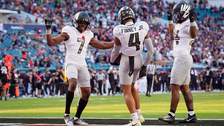 Oregon defensive back Ify Obidegwu, left, defensive back Brandon Finney Jr. and inside linebacker Jerry Mixon celebrate an interception by Finney as the Oregon Ducks take on the Texas Tech Red Raiders in the Orange Bowl on Jan. 1, 2026, at Hard Rock Stadium in Miami, Florida.