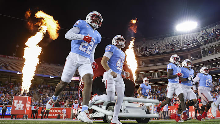 Nov 23, 2024; Houston, Texas, USA; Houston Cougars players run onto the field before the game against the Baylor Bears