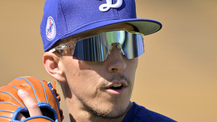 Jun 19, 2025; Los Angeles, California, USA;  Los Angeles Dodgers second baseman Tommy Edman (25) warms up prior to the game against the Los Angeles Dodgers at Dodger Stadium. Mandatory Credit: Jayne Kamin-Oncea-Imagn Images