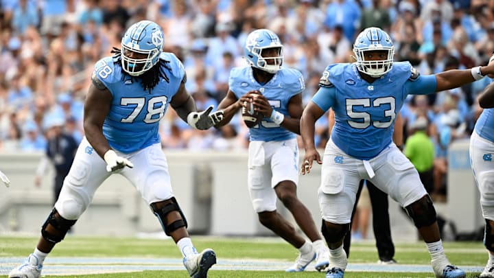 North Carolina Tar Heels QB Conner Harrell (15) looks to pass as offensive linemen Trevyon Green (78) and Willie Lampkin (53) block. Mandatory Credit: Bob Donnan-Imagn Images