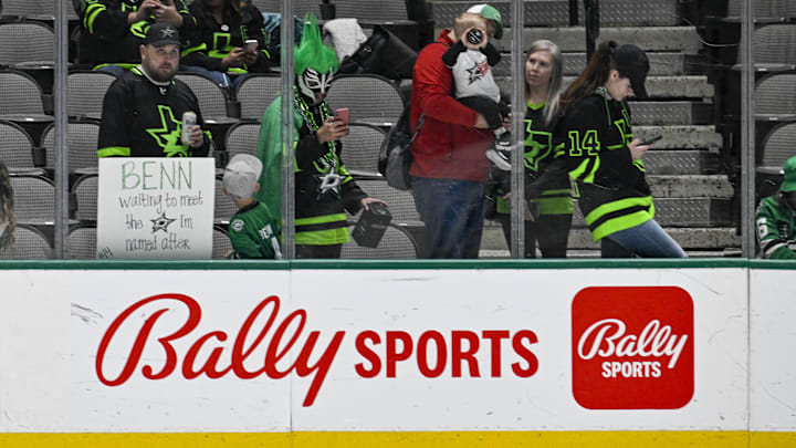 Apr 8, 2023; Dallas, Texas, USA; A view of the Bally Sports logo and a Dallas Stars fan.