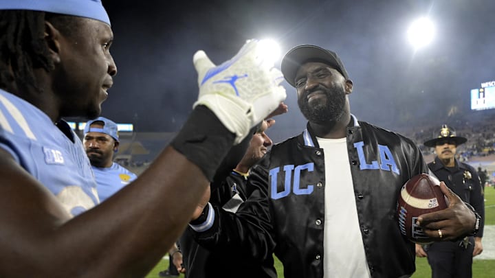 Nov 8, 2024; Pasadena, California, USA;  UCLA Bruins head coach DeShaun Foster shakes hands with running back T.J. Harden (25) after defeating the Iowa Hawkeyes at the Rose Bowl. Mandatory Credit: Jayne Kamin-Oncea-Imagn Images