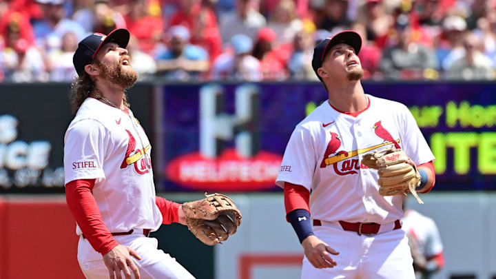 Apr 13, 2025; St. Louis, Missouri, USA; St. Louis Cardinals infielder Brendan Donovan (33, left) and St. Louis Cardinals second baseman Nolan Gorman (16) track an infield pop fly during a game against the Philadelphia Phillies at Busch Stadium. Mandatory Credit: Tim Vizer-Imagn Images