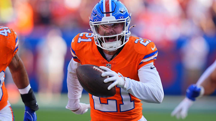 Oct 6, 2024; Denver, Colorado, USA; Denver Broncos cornerback Riley Moss (21) celebrates his interception in the second half against the Las Vegas Raiders at Empower Field at Mile High. Mandatory Credit: Ron Chenoy-Imagn Images