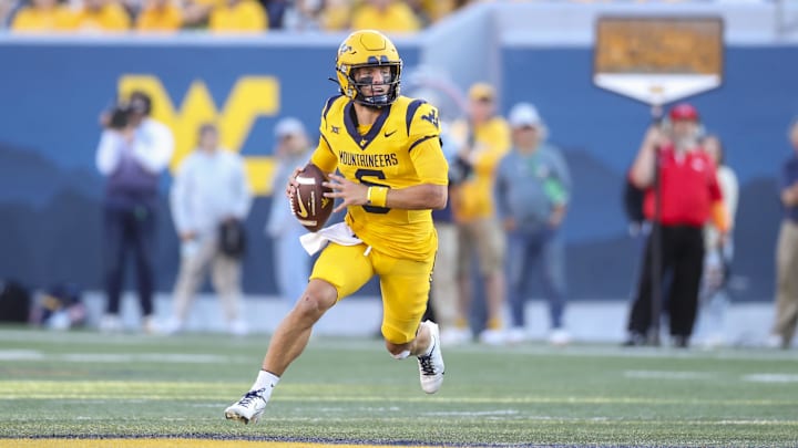 Sep 7, 2024; Morgantown, West Virginia, USA; West Virginia Mountaineers quarterback Garrett Greene (6) rolls out to pass during the first quarter against the Albany Great Danes at Mountaineer Field at Milan Puskar Stadium. Mandatory Credit: Ben Queen-Imagn Images