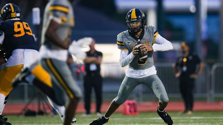 American Heritage Patriots quarterback Dia Bell (3) scrambles in the backfield during the first quarter of a game against the Naples Golden Eagles at Staver Field in Naples on Friday, Sept. 13, 2024. American Heritage Patriots quarterback Dia Bell (3) scrambles in the backfield during the first quarter of a game against the Naples Golden Eagles at Staver Field in Naples on Friday, Sept. 13, 2024.