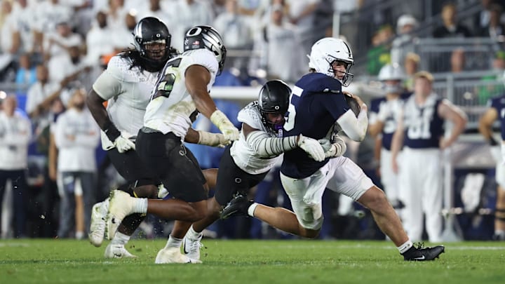  Penn State football quarterback Drew Allar (15) is tackled by Oregon Ducks linebacker Blake Purchase (9) during the fourth quarter at Beaver Stadium