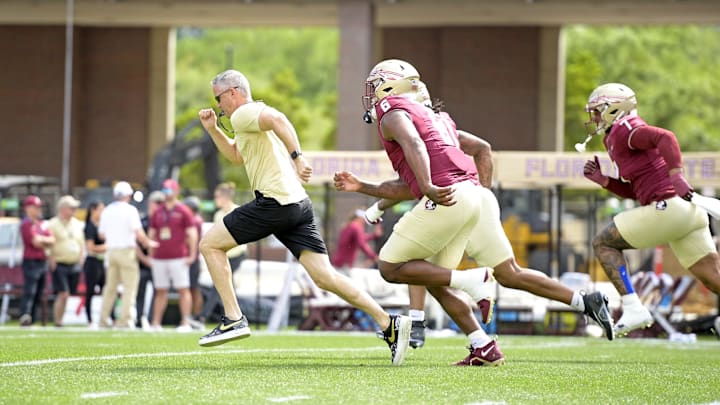 Apr 20, 2024; Tallahassee, Florida, USA; Florida State Seminoles head coach Mike Norvell races some of his players to the other end of the field during the Spring Showcase at Doak S. Campbell Stadium. Mandatory Credit: Melina Myers-USA TODAY Sports