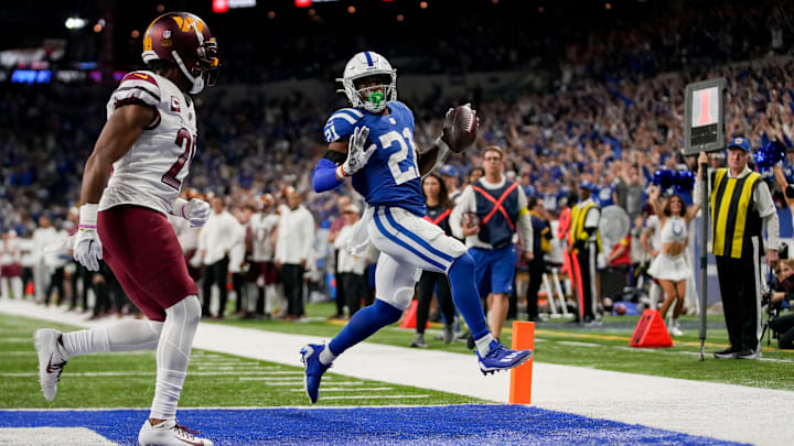 Indianapolis Colts running back Nyheim Hines (21) runs the ball in ahead of Washington Commanders cornerback Kendall Fuller (29) for a touchdown Sunday, Oct. 30, 2022, during a game against the Washington Commanders at Indianapolis Colts at Lucas Oil Stadium in Indianapolis. Indianapolis Colts running back Nyheim Hines (21) runs the ball in ahead of Washington Commanders cornerback Kendall Fuller (29) for a touchdown Sunday, Oct. 30, 2022, during a game against the Washington Commanders at Indianapolis Colts at Lucas Oil Stadium in Indianapolis.