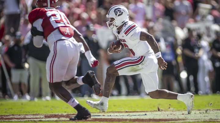 Oct 12, 2024; Tuscaloosa, Alabama, USA;  South Carolina Gamecocks quarterback LaNorris Sellers (16) runs the ball against Alabama Crimson Tide defensive lineman Jah-Marien Latham (20) during the second quarter at Bryant-Denny Stadium. Mandatory Credit: Will McLelland-Imagn Images