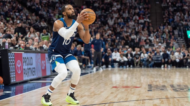 Apr 13, 2025; Minneapolis, Minnesota, USA; Minnesota Timberwolves guard Mike Conley (10) shoots a three-point shot against the Utah Jazz in the second quarter at Target Center. Mandatory Credit: Matt Blewett-Imagn Images