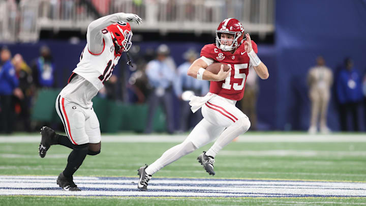 Dec 6, 2025; Atlanta, GA, USA; Alabama Crimson Tide quarterback Ty Simpson (15) rushes as Georgia Bulldogs linebacker Zayden Walker (10) defends during the fourth quarter during the 2025 SEC Championship game at Mercedes-Benz Stadium. Mandatory Credit: Brett Davis-Imagn Images