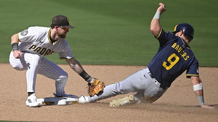 Sep 24, 2025; San Diego, California, USA; Milwaukee Brewers left fielder Jake Bauers (9) is tagged out by San Diego Padres second baseman Jake Cronenworth (9) as he tries to steal second base during the sixth inning at Petco Park. Mandatory Credit: Denis Poroy-Imagn Images