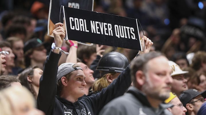 Feb 8, 2025; Morgantown, West Virginia, USA; A West Virginia Mountaineers student holds up a sign on Coal Rush night during the second half against the Utah Utes at WVU Coliseum. Mandatory Credit: Ben Queen-Imagn Images