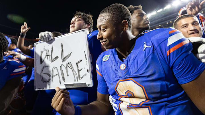 Nov 16, 2024; Gainesville, Florida, USA; Florida Gators quarterback DJ Lagway (2) gestures towards a sign held by Florida Gators offensive lineman Austin Barber (58) after a game against the LSU Tigers at Ben Hill Griffin Stadium. Mandatory Credit: Matt Pendleton-Imagn Images