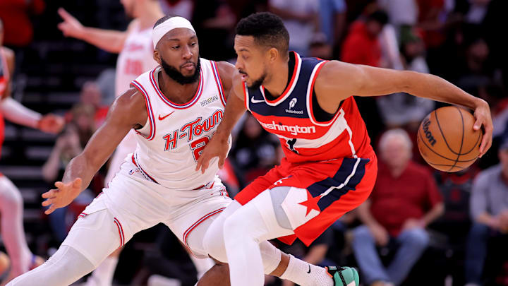 Nov 12, 2025; Houston, Texas, USA; Washington Wizards guard CJ McCollum (3) handles the ball against Houston Rockets guard Josh Okogie (20) during the first quarter at Toyota Center. Mandatory Credit: Erik Williams-Imagn Images