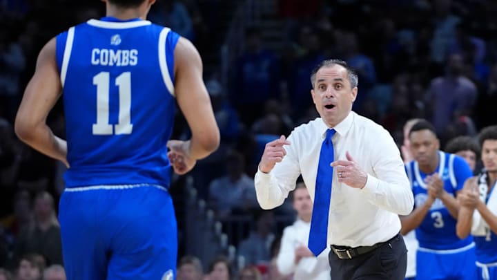 Mar 22, 2025; Wichita, KS, USA; Drake Bulldogs head coach Ben McCollum talks with guard Kael Combs (11) during the second half at Intrust Bank Arena. Mandatory Credit: Kirby Lee-Imagn Images