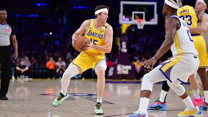 Apr 3, 2025; Los Angeles, California, USA: Los Angeles Lakers guard Austin Reaves (15) moves the ball against Golden State Warriors forward Jimmy Butler III (10) during the first half at Crypto.com Arena. Mandatory Credit: Gary A. Vasquez-Imagn Images