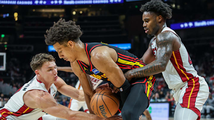 Dec 26, 2025; Atlanta, Georgia, USA; Atlanta Hawks forward Jalen Johnson (1) fights for the ball against Miami Heat guard Pelle Larsson (9) and Miami Heat guard Davion Mitchell (45) during the fourth quarter at State Farm Arena. Mandatory Credit: Jordan Godfree-Imagn Images Dec 26, 2025; Atlanta, Georgia, USA; Atlanta Hawks forward Jalen Johnson (1) fights for the ball against Miami Heat guard Pelle Larsson (9) and Miami Heat guard Davion Mitchell (45) during the fourth quarter at State Farm Arena. Mandatory Credit: Jordan Godfree-Imagn Images