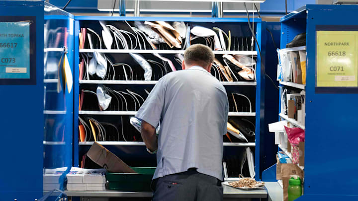 An employee sorts mail Monday morning at the Topeka Sorting and Delivery Center.