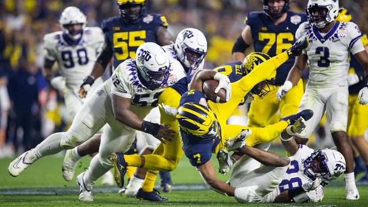 Dec 31, 2022; Glendale, Arizona, USA; Michigan Wolverines running back Donovan Edwards (7) is Dec 31, 2022; Glendale, Arizona, USA; Michigan Wolverines running back Donovan Edwards (7) is