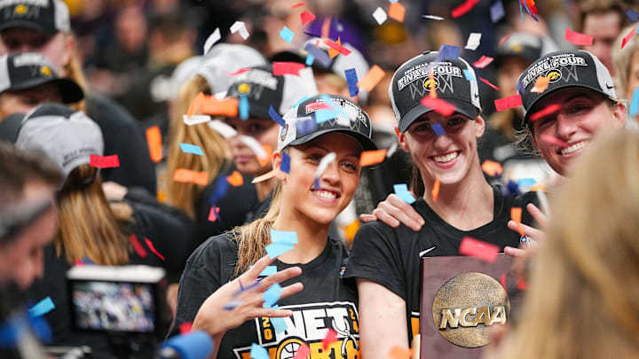 Iowa Hawkeyes guard Gabbie Marshall (24) guard Caitlin Clark (22) and guard Kate Martin (20) hold