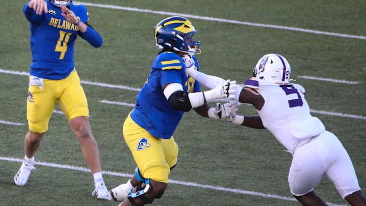 Delaware quarterback Nick Minicucci (4) throws in front of Anwar O'neal as he blocks against Albany's Ibrahim Sanogo in the third quarter of the Blue Hens' 28-14 win at Delaware Stadium, Saturday, Oct. 26, 2024. Delaware quarterback Nick Minicucci (4) throws in front of Anwar O'neal as he blocks against Albany's Ibrahim Sanogo in the third quarter of the Blue Hens' 28-14 win at Delaware Stadium, Saturday, Oct. 26, 2024.