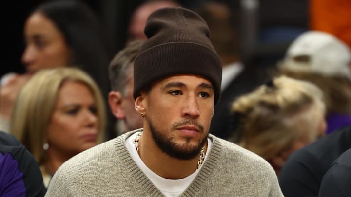 Dec 27, 2024; Phoenix, Arizona, USA; Injured Phoenix Suns guard Devin Booker sits on the bench against the Dallas Mavericks at Footprint Center. Mandatory Credit: Mark J. Rebilas-Imagn Images Dec 27, 2024; Phoenix, Arizona, USA; Injured Phoenix Suns guard Devin Booker sits on the bench against the Dallas Mavericks at Footprint Center. Mandatory Credit: Mark J. Rebilas-Imagn Images