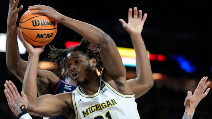 Michigan Wolverines forward Morez Johnson Jr. (21) drives past UConn Huskies guard Solo Ball (1) for the score Monday, April 6, 2026, during the NCAA men’s basketball national championship game at Lucas Oil Stadium in Indianapolis.