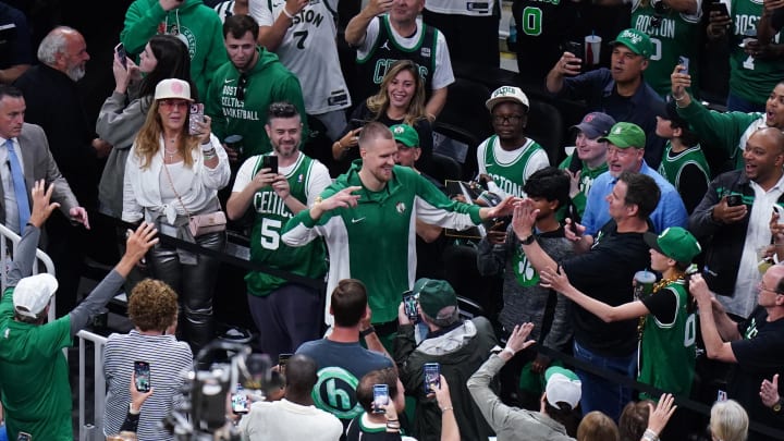 Jun 9, 2024; Boston, Massachusetts, USA; Boston Celtics center Kristaps Porzingis (8) greets fans as he walks onto the court before game two against the Dallas Mavericks in the 2024 NBA Finals at TD Garden. Mandatory Credit: David Butler II-USA TODAY Sports