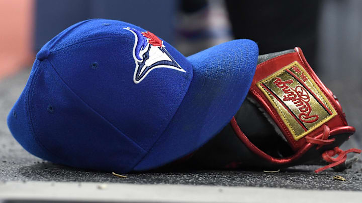 A baseball cap and glove sit on the Toronto Blue Jays dugout steps as they host the Seattle Mariners in their home opener at Rogers Centre in Toronto on April 8, 2024.  