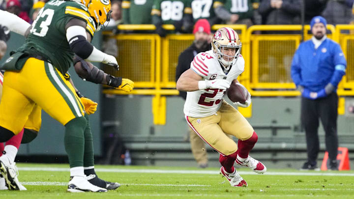 Nov 24, 2024; Green Bay, Wisconsin, USA;  San Francisco 49ers running back Christian McCaffrey (23) rushes with the football during the first quarter against the Green Bay Packers at Lambeau Field. Mandatory Credit: Jeff Hanisch-Imagn Images