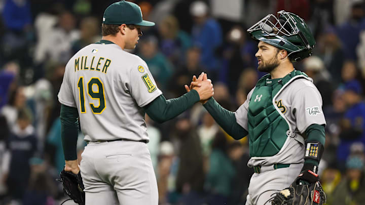 Athletics relief pitcher Mason Miller shakes hands with catcher Shea Langeliers following a strikeout against the Seattle Mariners to end the ninth inning at T-Mobile Park. 